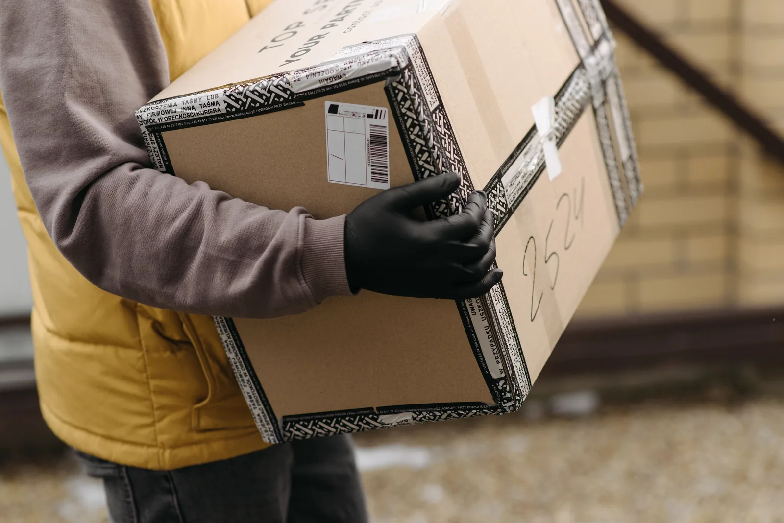 Courier carrying a securely taped parcel