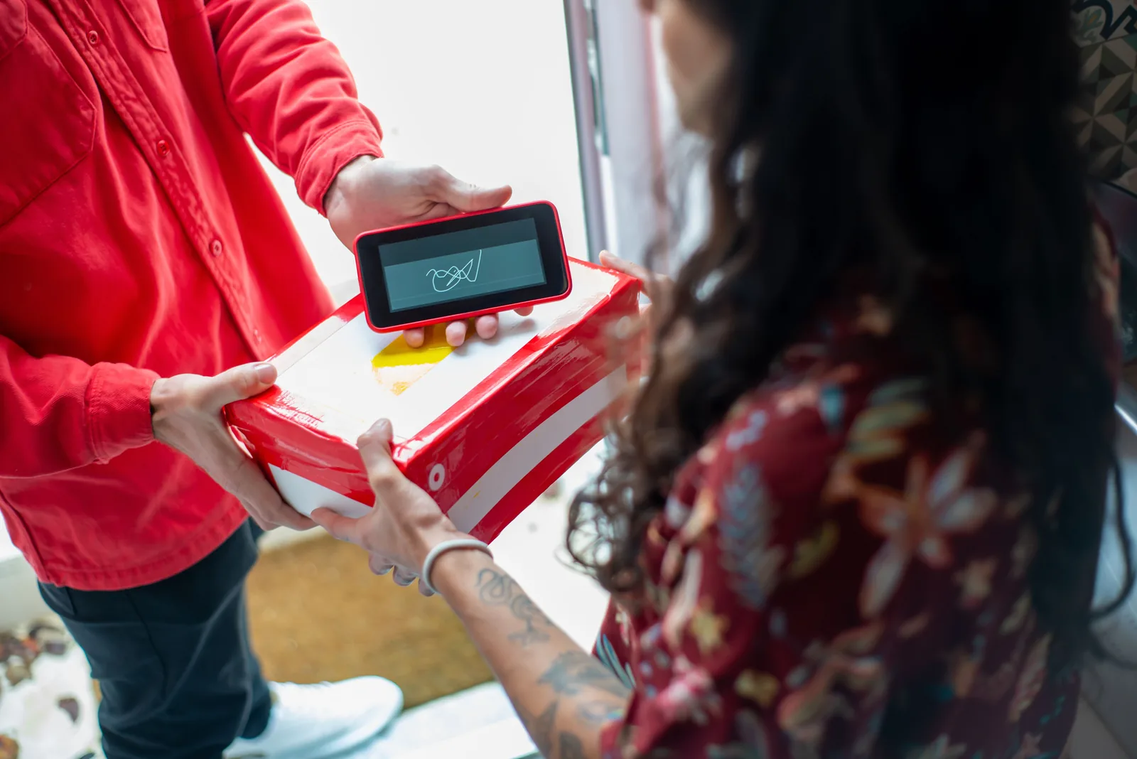 Courier handing a parcel to a customer