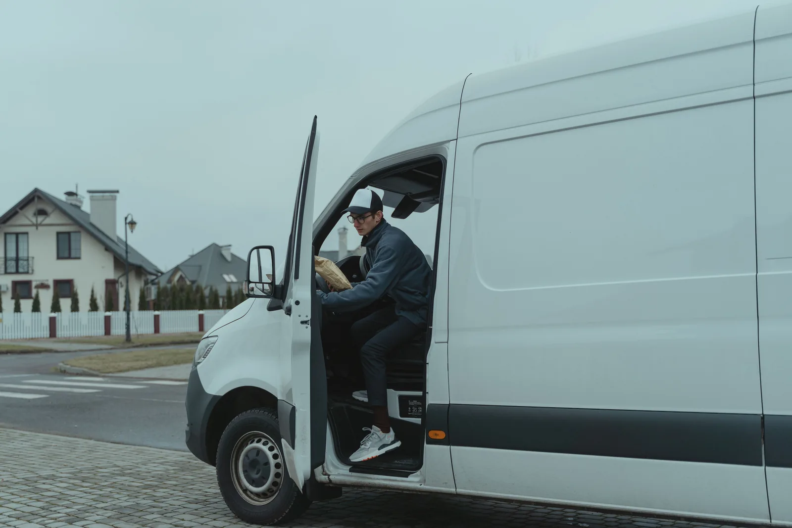 Courier stepping out of a delivery van
